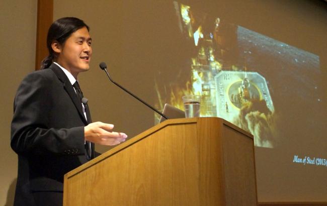 man lecturing at podium